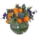 Centrepiece with orange roses and greenery (diam 15 cm)